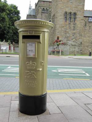 Golden Postbox opposite Cardiff Castle Clock Tower